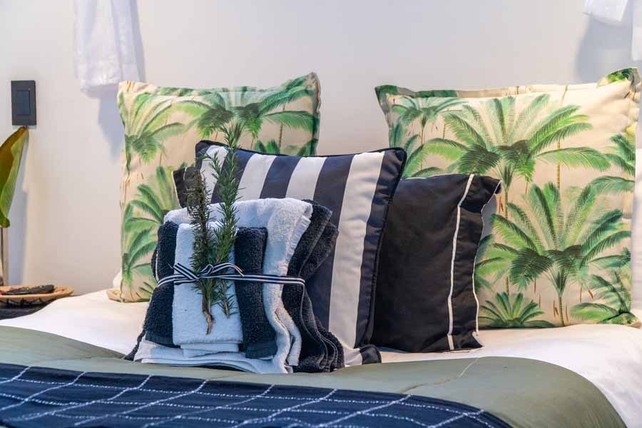 Palm-print cushions on the Garden Room bed