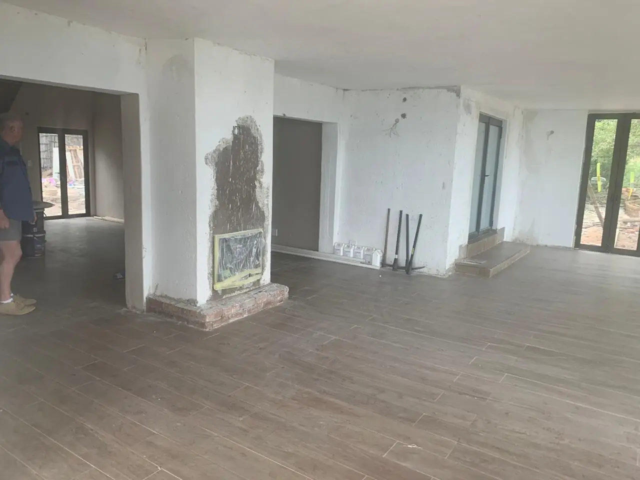 Open-plan interior with fireplace during construction