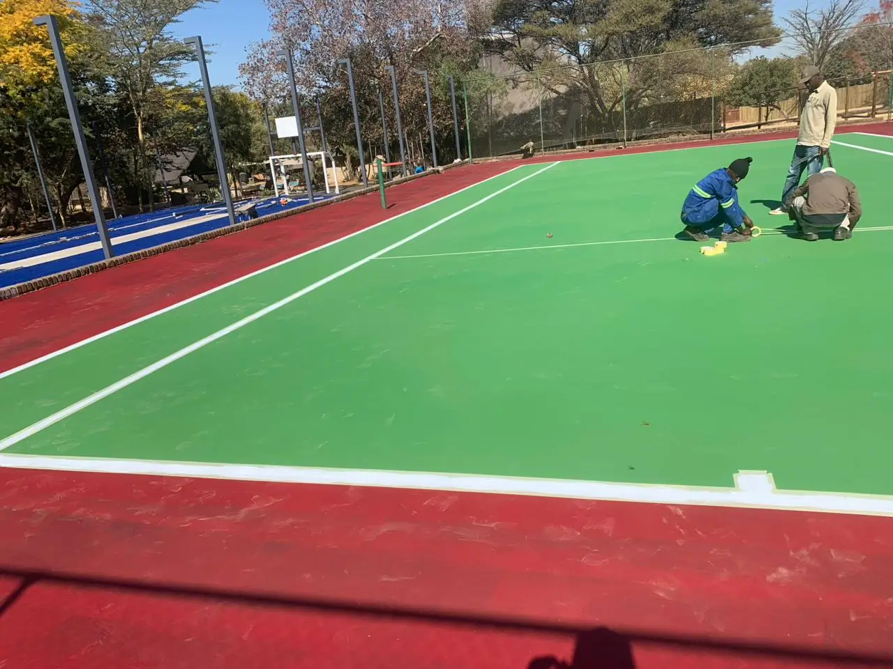 Tennis court line marking in progress