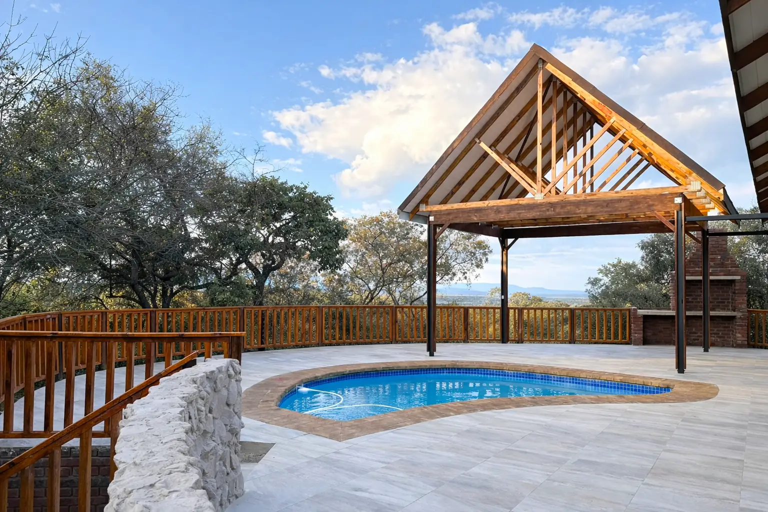 Timber lapa roof structure over a pool deck