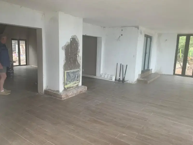 Open-plan interior with fireplace during construction