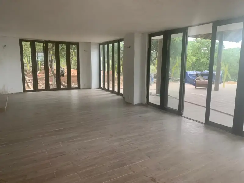 Living area with floor-to-ceiling aluminium folding doors