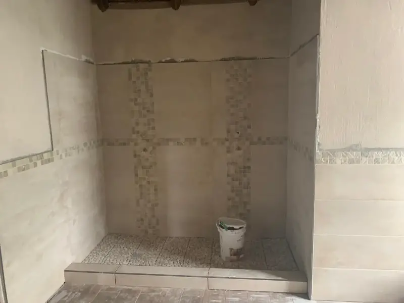 Walk-in shower tiling with mosaic feature strip